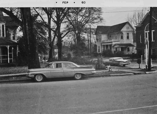 Main street 1960 at the time the large trees lining Main Street were cut down to make room for street widening. Rogan house at left, Reid house in middle, Baptist Church at right.